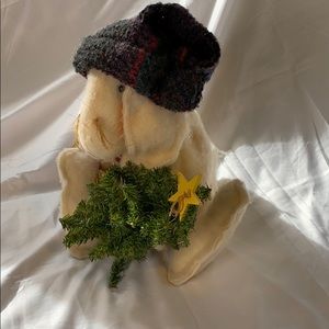 Handmade stuffed rabbit holding xmas tree